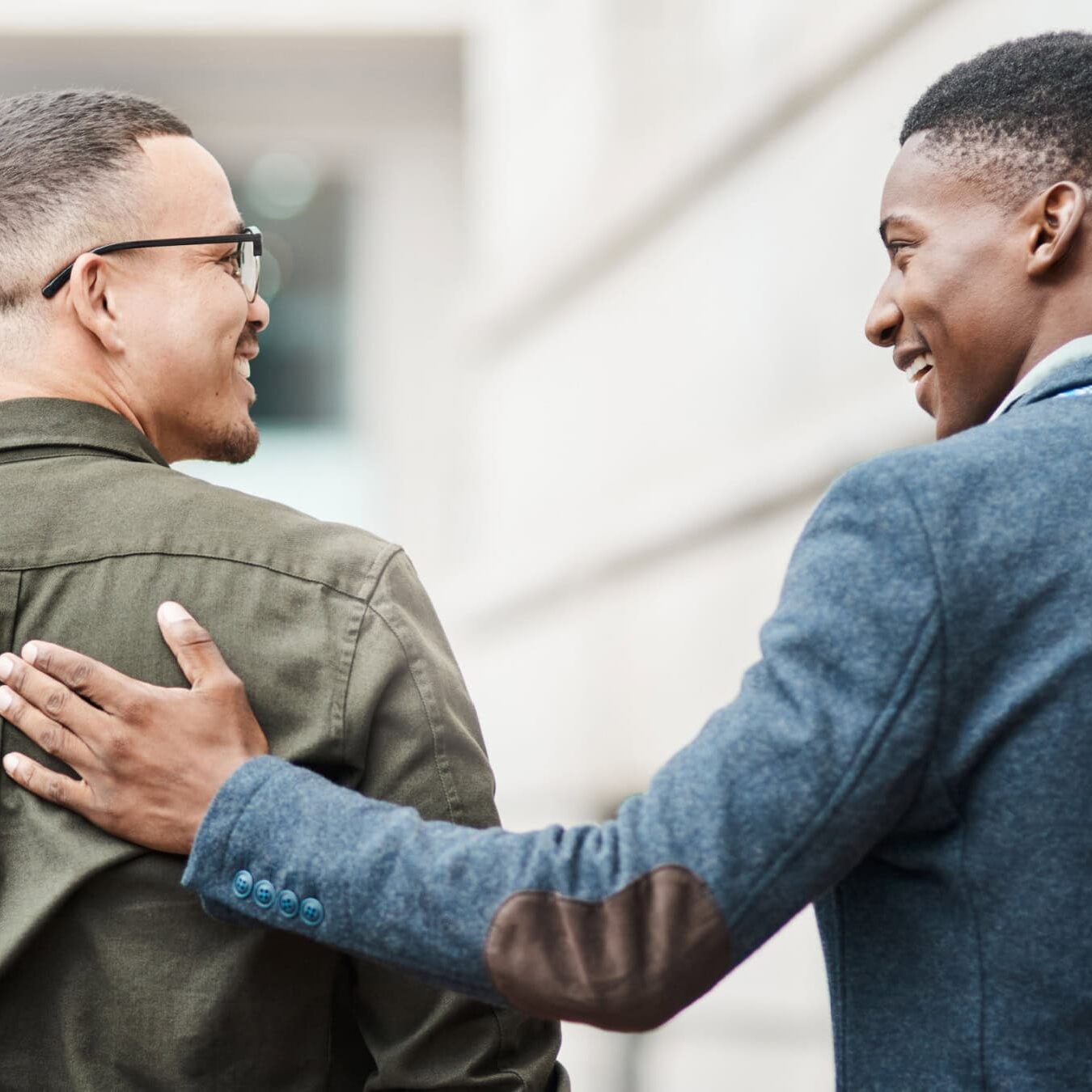 icf-briding-gap-consumer-awareness Two men walk outside sharing a casual touch, like they are friends