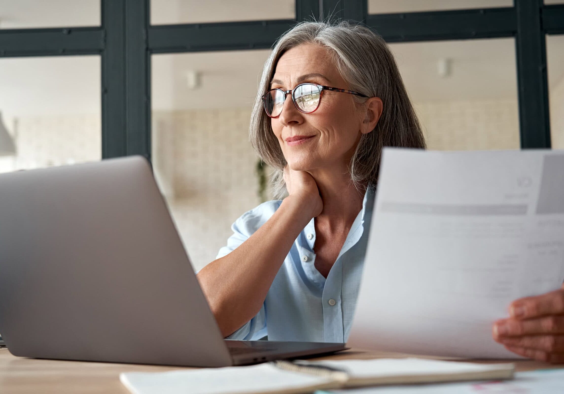 Smiling,Mature,Middle,Aged,Business,Woman,Using,Laptop,Working,On Coach participating in continuous learning to stay current with coaching trends.