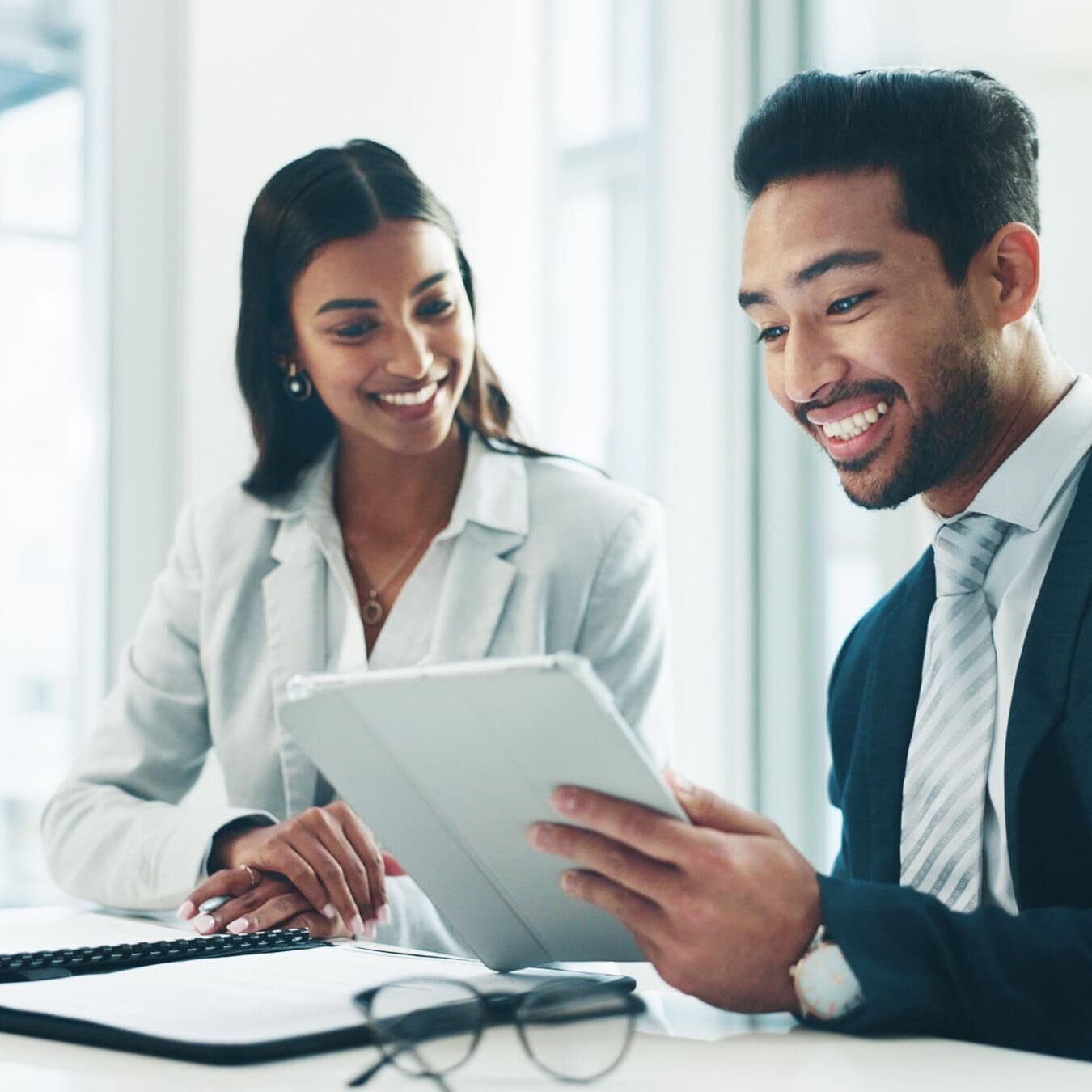 icf-global-coaching-study-research Two people use a tablet to explore research from ICF