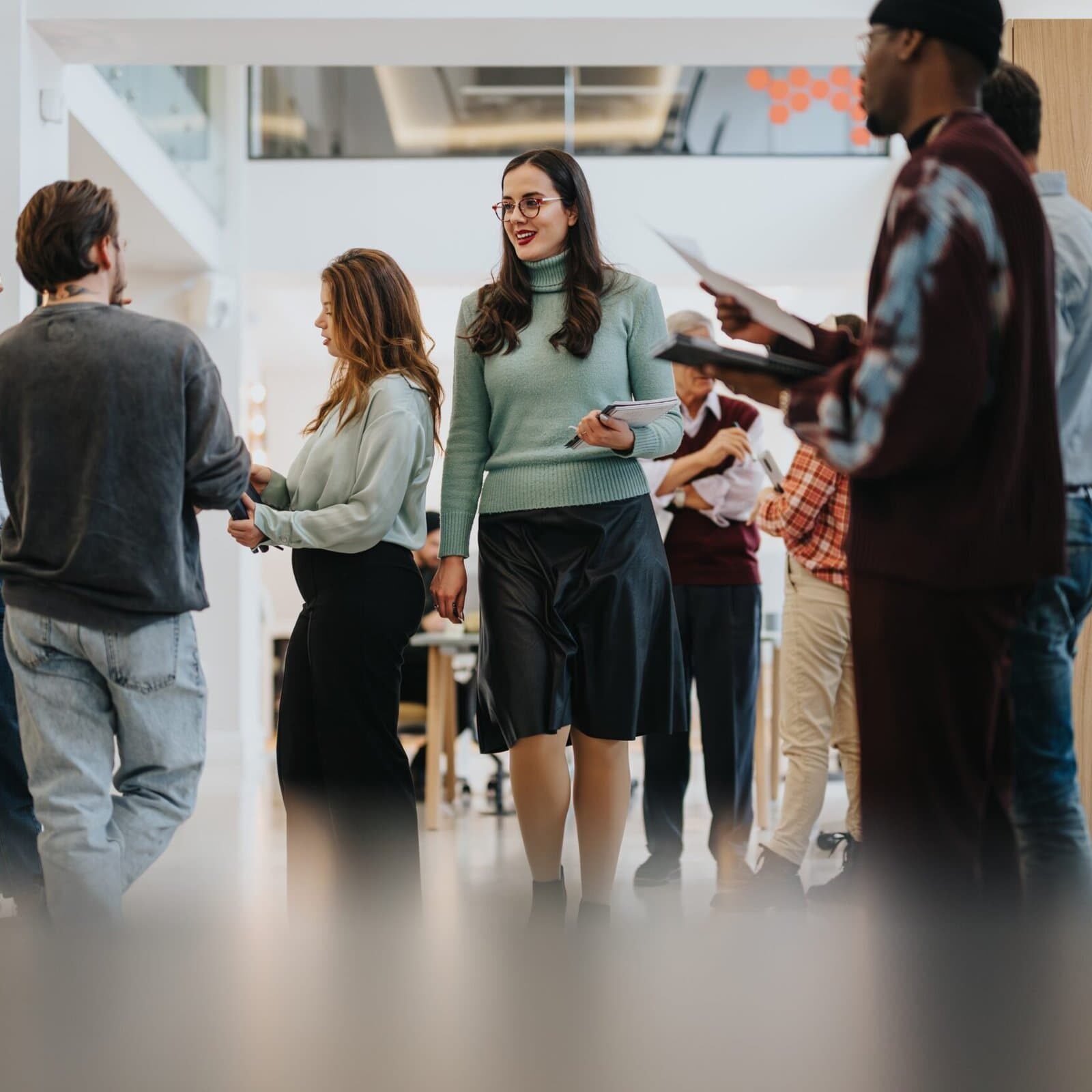 A,Group,Of,Multiracial,Colleagues,Engaging,In,A,Casual,Conversation group of coaches at a networking event